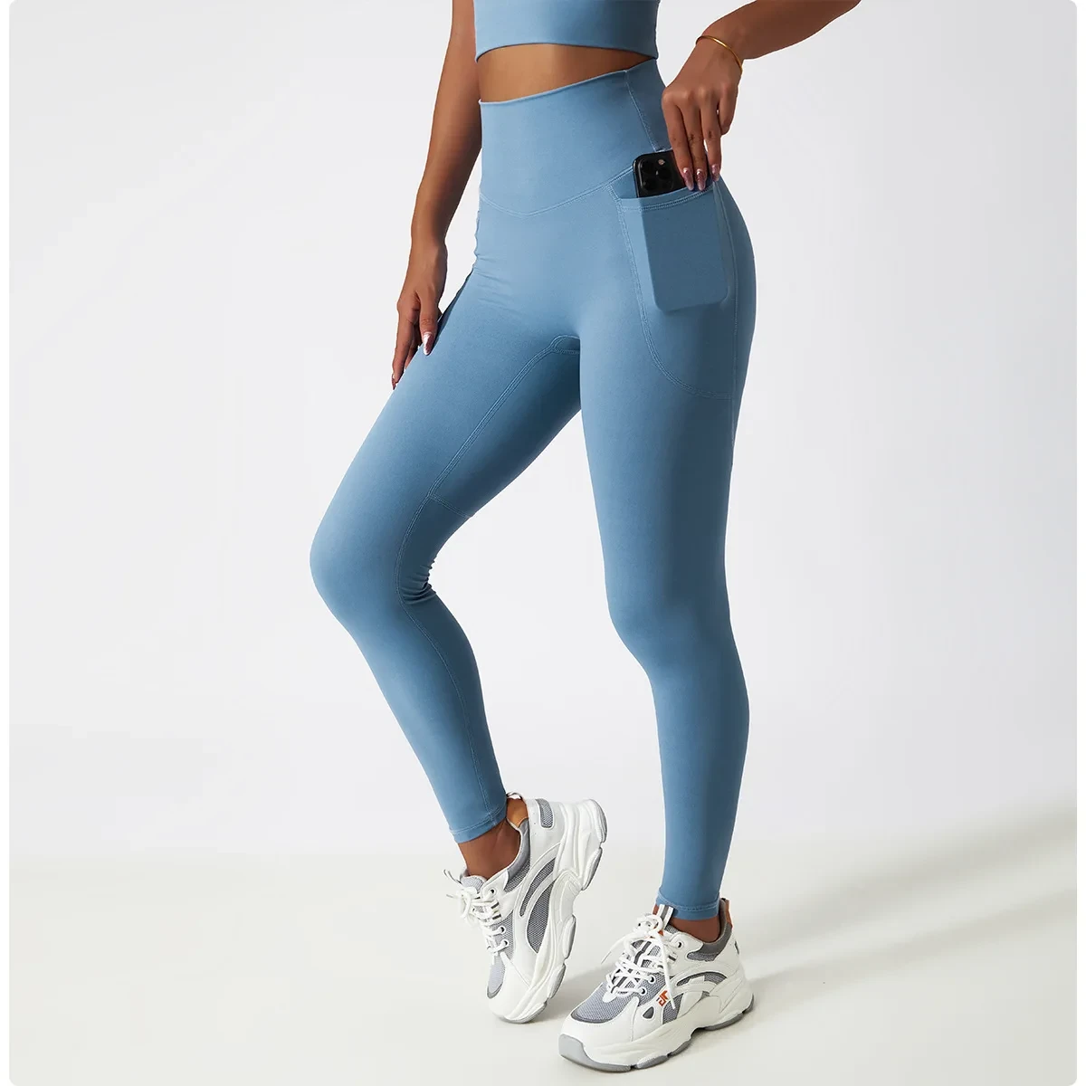 Legging de sport bleu femme à poche avec taille haute, matière respirante, et poche latérale