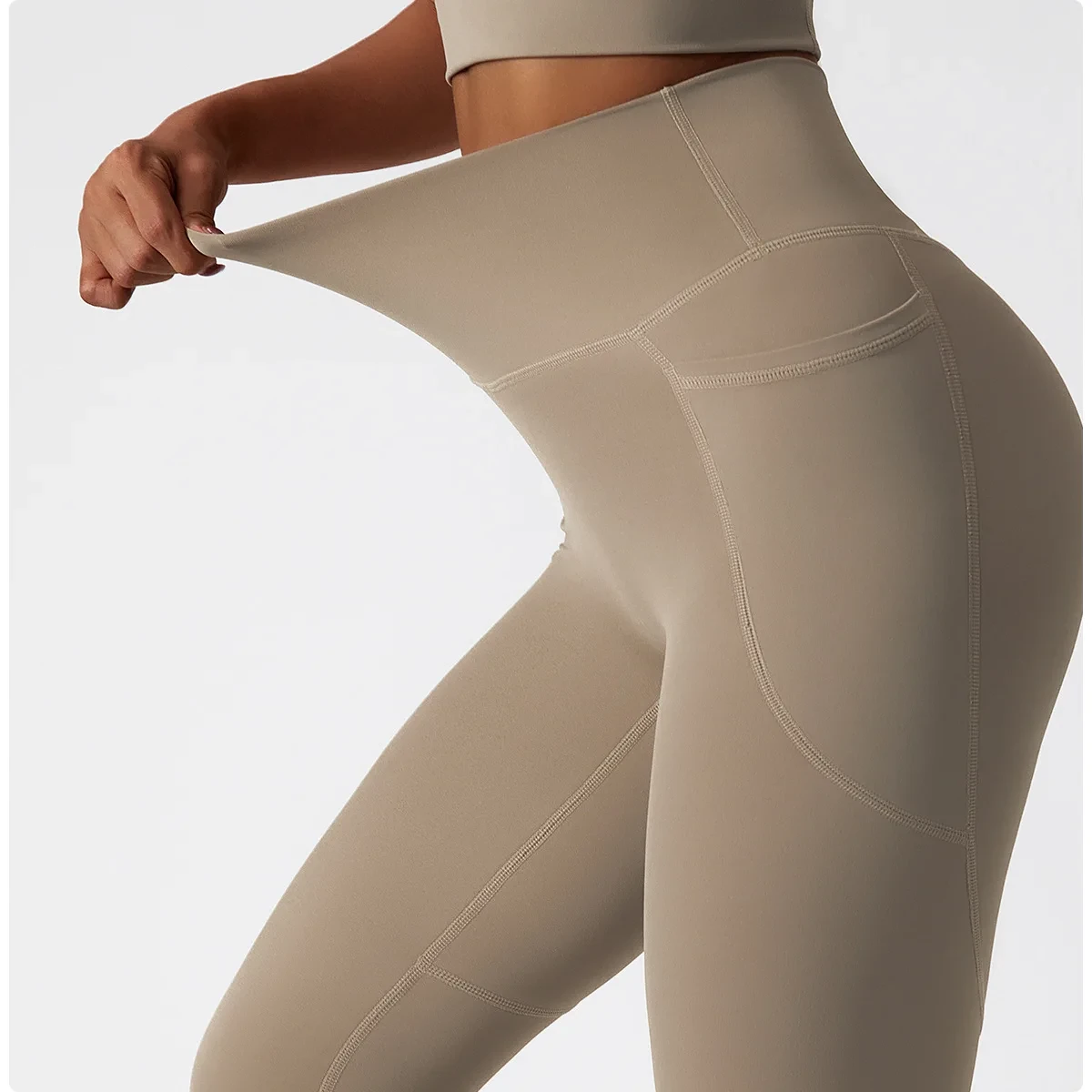 Legging de sport femme à poche avec taille haute, matière respirante, et poche latérale